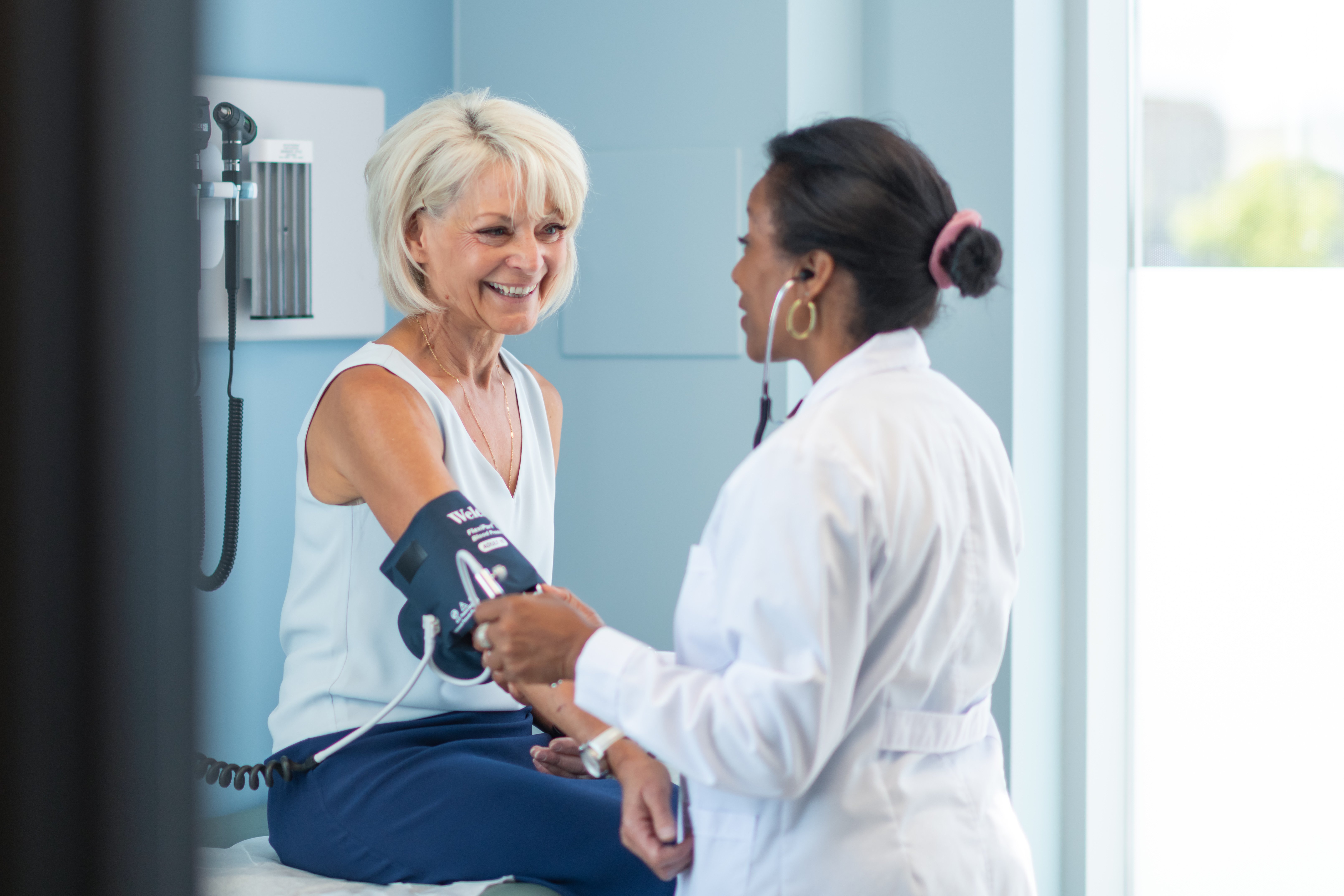 Photo of a medical professional taking a woman's blood pressure